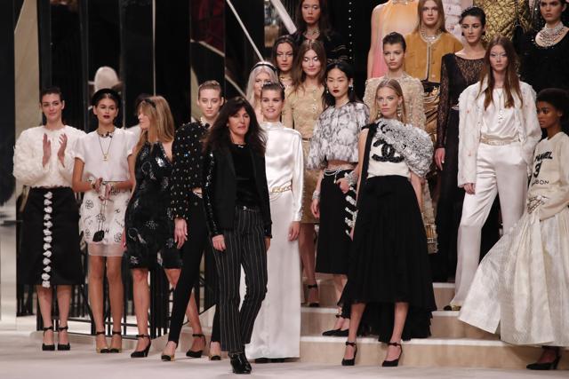 French fashion designer Virginie Viard, center, acknowledges applauses after the presentation of Chanel's Metiers d'Art collection at the Grand Palais in Paris, Wednesday, Dec.4, 2019. (AP Photo/Francois Mori) (AP) French fashion designer Virginie Viard, center, acknowledges applauses after the presentation of Chanel's Metiers d'Art collection at the Grand Palais in Paris, Wednesday, Dec.4, 2019. (AP Photo/Francois Mori) (AP)