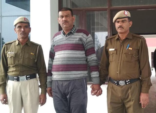 Home guard volunteer Jashan Pal in the custody of Panchkula police. (HT Photo) Home guard volunteer Jashan Pal in the custody of Panchkula police. (HT Photo)