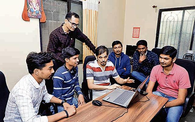 Dnyaneshwar Nerkar (standing) and Siddhant Chothe (third from left) are at the heart of Tekvision’s software for the blind. Tekvision now employs six people. (Rahul Raut/HT PHOTO)