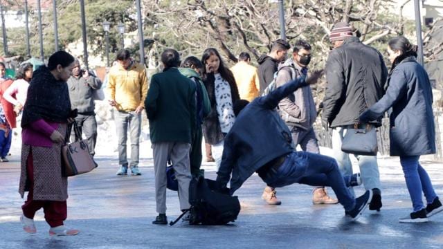 A pedestrian taking a fall due to the slippery road at the Ridge in Shimla. (Deepak Sansta/HT) A pedestrian taking a fall due to the slippery road at the Ridge in Shimla. (Deepak Sansta/HT)
