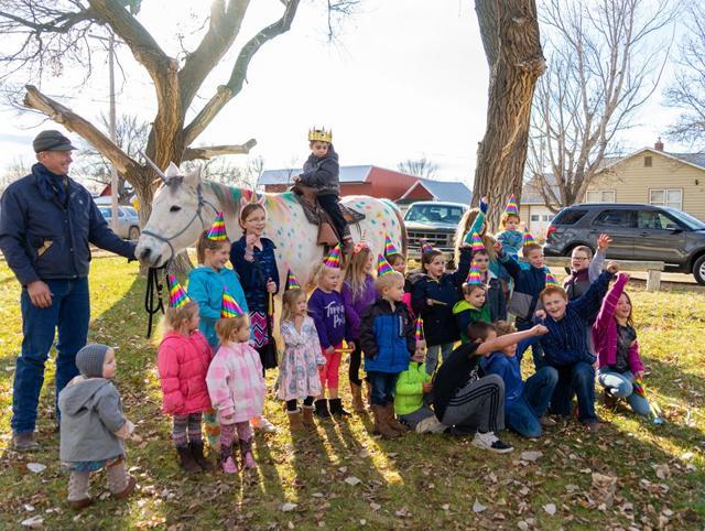 Wyatt sitting on ‘unicorn’, and surrounded by friends. Wyatt sitting on ‘unicorn’, and surrounded by friends.
