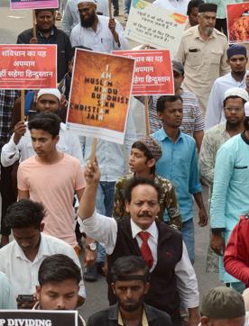 People hold placards during the protest against CAA at Pune collector’s office. (Shankar Narayan/HT PHOTO)