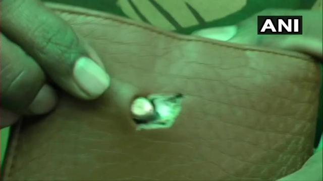 The bullet got stuck in his wallet inside his jacket. (Photo: ANI) The bullet got stuck in his wallet inside his jacket. (Photo: ANI)