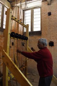 Victor Den operating the bell by pulling ropes at the Christ Church at Ridge in Shimla. (Deepak Sansta/HT)