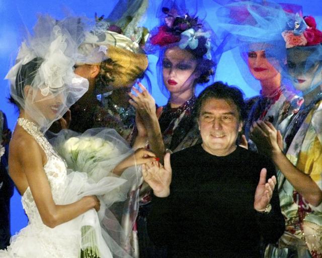 FILE - In this Wednesday, Jan. 22, 2003 file photo French fashion designer Emanuel Ungaro acknowledges applause at the end of his spring summer Haute Couture 2003 fashion collection presented in Paris. Fashion house Emanuel Ungaro says that French designer Emanuel Ungaro has died at the age of 86. The house posted Sunday, Dec. 22, 2019 on Instagram that Ungaro “will remain in our memories as the Master of sensuality, of color and flamboyance." Ungaro has died on Saturday in Paris, according to French medias. Renowned for his use of vibrant colors, mixed prints and elegant draping, Ungaro founded the house that bears his name in 1965. He retired from fashion in 2004. (AP Photo/Laurent Rebours, File) (AP)