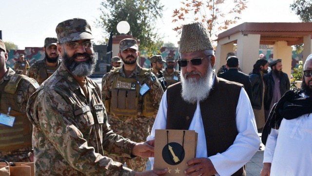 ASWJ leader Ahmed Ludhianvi being presented a memento at a Pakistan Army base in North Waziristan. (Sourced) ASWJ leader Ahmed Ludhianvi being presented a memento at a Pakistan Army base in North Waziristan. (Sourced)