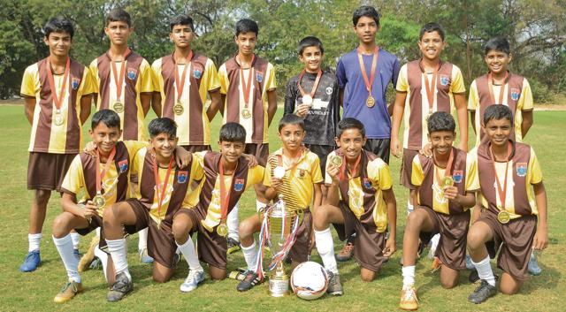 Players of St Vincent’s U-14 category pose with medals and trophy after winning the 7th Loyola Cup played at Loyola football ground on Monday. (MILIND SAURKAR/HT)