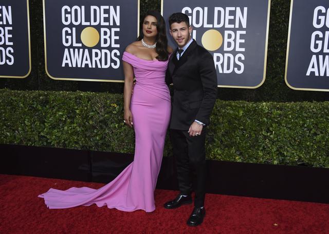 Priyanka Chopra, left, and Nick Jonas arrive at the 77th annual Golden Globe Awards. (Jordan Strauss/Invision/AP)