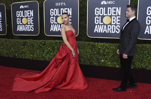 Scarlett Johansson, left, arrives as Colin Jost looks on. (Jordan Strauss/Invision/AP)