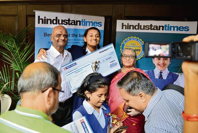 Winning students and their families celebrate the moment at the Hindustan Times Scholarship programme event on Thursday. (Shankar Narayan/HT PHOTO)
