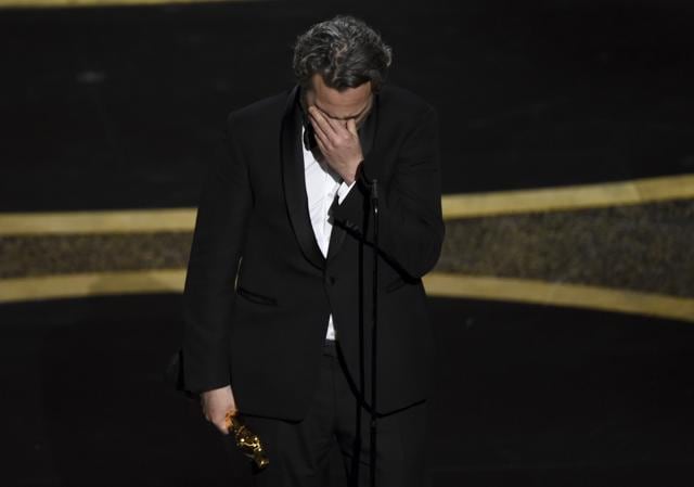 Joaquin Phoenix reacts as he accepts the award for best performance by an actor in a leading role for Joker. (Chris Pizzello/Invision/AP) Joaquin Phoenix reacts as he accepts the award for best performance by an actor in a leading role for Joker. (Chris Pizzello/Invision/AP)