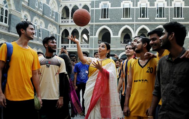 Bollywood actor Vidya Balan plays with basketball as students looks on after attending a conference on Art Meets Academia at a college in Mumbai on Wednesday. Bollywood actor Vidya Balan plays with basketball as students looks on after attending a conference on Art Meets Academia at a college in Mumbai on Wednesday.