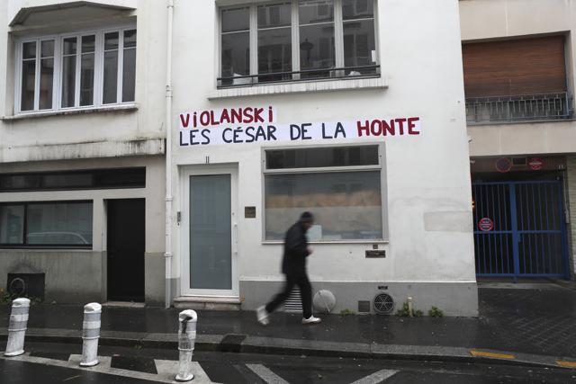 A man walks by the Academie des Cesar headquarters where a graffiti reads "Violanski, Cesar awards of shame", playing with the French word for rape and the name of Roman Polanski. (AP) A man walks by the Academie des Cesar headquarters where a graffiti reads "Violanski, Cesar awards of shame", playing with the French word for rape and the name of Roman Polanski. (AP)