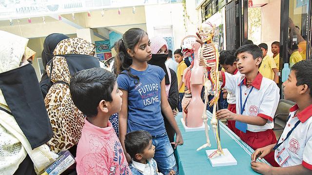 Students across various age groups get a close look at a satellite at IUCAA at the SPPU, on the ocassion of Science day on Friday. (HT PHOTO)