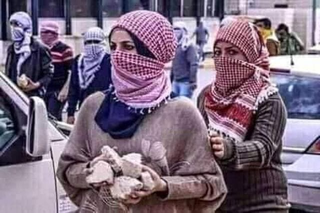 Two women holding stones. Two women holding stones.