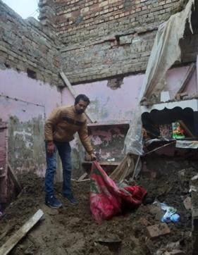 A man trying to retrieve whatever is left after the roof collapsed. (Sameer Sehgal/HT) A man trying to retrieve whatever is left after the roof collapsed. (Sameer Sehgal/HT)