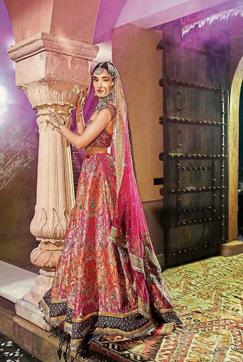 This lehenga is an antique king khaab handwoven brocade, embellished with zardosi and ari embroidery in gold, pearls and turquoise sequin with a velvet zardozi border edged with gota. The off-shoulder blouse creates a traditional yet modern look. The dupatta has been embellished with zardosi embroidery and is edged with tukri gota patti zardozi border. This lehenga is an antique king khaab handwoven brocade, embellished with zardosi and ari embroidery in gold, pearls and turquoise sequin with a velvet zardozi border edged with gota. The off-shoulder blouse creates a traditional yet modern look. The dupatta has been embellished with zardosi embroidery and is edged with tukri gota patti zardozi border.