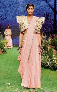 Give your pre-wedding functions a fun twist with this pleated ruffled Chanderi top with hand-crafted loop detailing. Team it with a textured Chanderi saree featuring a hand-crafted metallic loop border. (Pramod Thakur/HT) Give your pre-wedding functions a fun twist with this pleated ruffled Chanderi top with hand-crafted loop detailing. Team it with a textured Chanderi saree featuring a hand-crafted metallic loop border. (Pramod Thakur/HT)