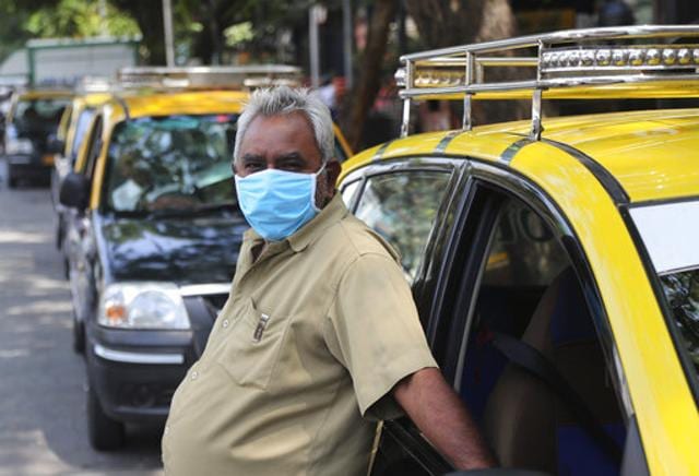 A taxi driver wearing a mask waits for customers in Mumbai, India, Sunday. (AP) A taxi driver wearing a mask waits for customers in Mumbai, India, Sunday. (AP)