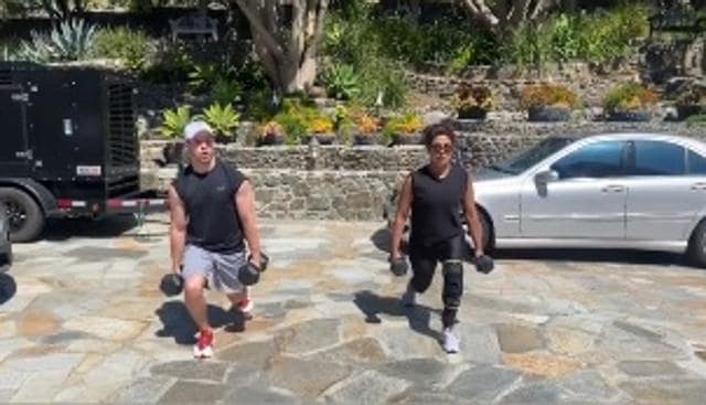 Nick Jonas and Priyanka Chopra doing squats together.