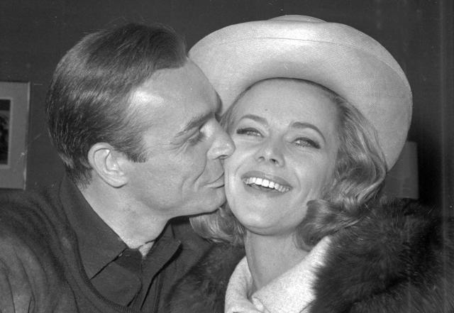 In this B/W file photo dated March 25, 1964, British actor Sean Connery kisses actress Honor Blackman during a party at Pinewood Film Studios. (AP) In this B/W file photo dated March 25, 1964, British actor Sean Connery kisses actress Honor Blackman during a party at Pinewood Film Studios. (AP)