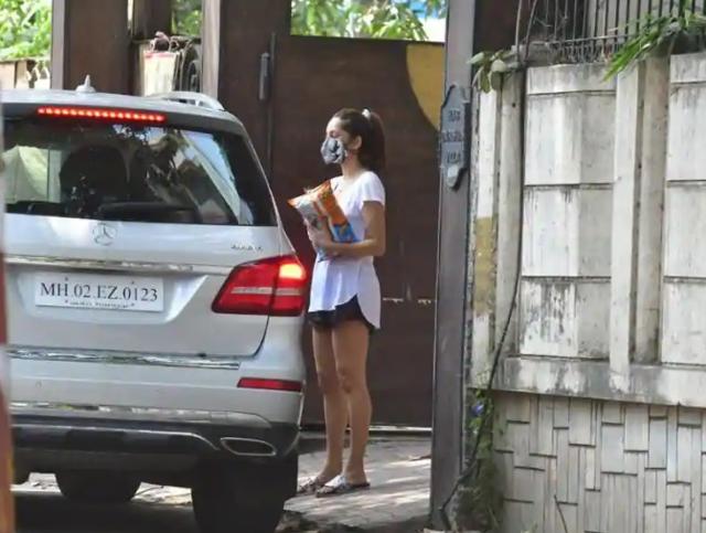 Anusha Dandekar near Farhan Akhtar’s car. Anusha Dandekar near Farhan Akhtar’s car.