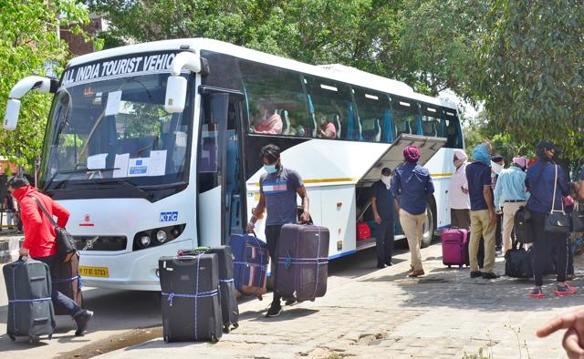 NRIs boarding in the special buses from Ludhiana to take them to Delhi airport on Saturday. (Gurpreet Singh/HT)