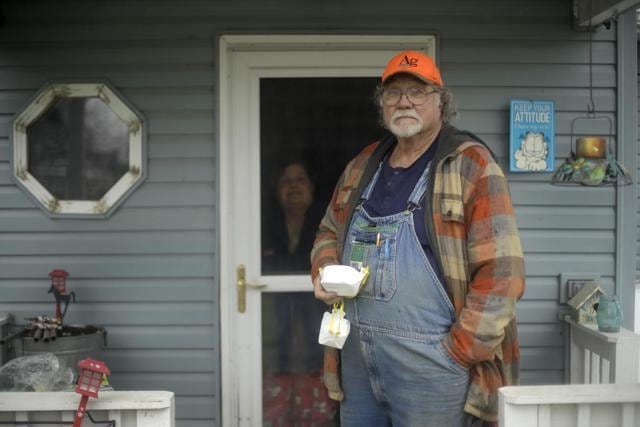Dennis Ruhnke holds two of his remaining N-95 masks as he stands with his wife, Sharon at their home near Troy, Kansas. (AP) Dennis Ruhnke holds two of his remaining N-95 masks as he stands with his wife, Sharon at their home near Troy, Kansas. (AP)