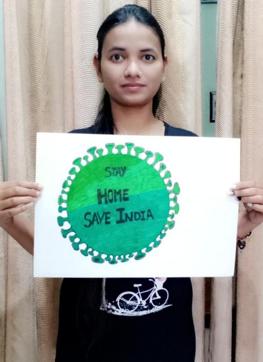 A student of Arya College with a poster displaying a message on the importance of staying home amid the coronavirus lockdown. (Ht Photo)
