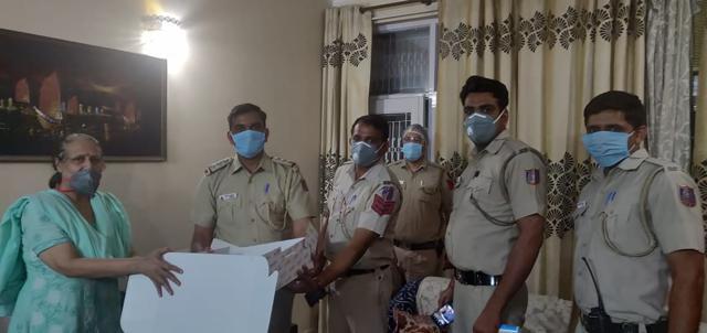 Cops handing the cake to Khanna. Cops handing the cake to Khanna.