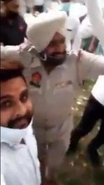 A grab of the video showing the police personnel and volunteers dancing at the party in Ludhiana on Monday night. (HT Photo)