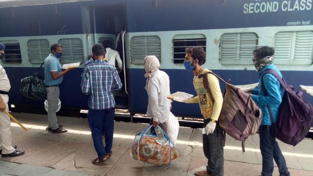 Government Railway Police helping passengers board a train at the Ludhiana railway station on Wednesday. The district administration provided them food for the journey. (Gurpreet Singh/HT) Government Railway Police helping passengers board a train at the Ludhiana railway station on Wednesday. The district administration provided them food for the journey. (Gurpreet Singh/HT)