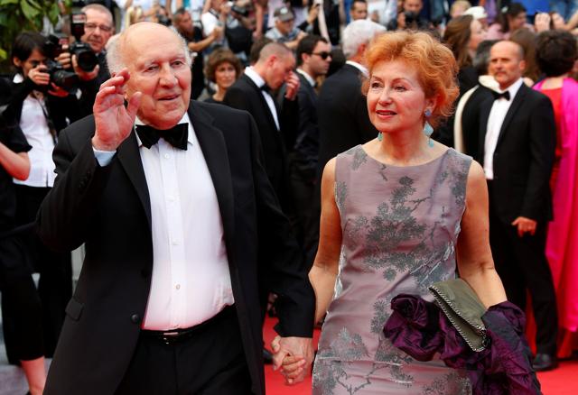 Actor Michel Piccoli (L) and his wife Ludivine Clerc pose on the red carpet as they arrive for the screening of the film Saint Laurent in competition at the 67th Cannes Film Festival in Cannes May 17, 2014. (REUTERS)