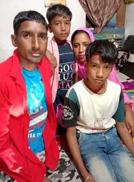 Shalu, a coolie, with his family at his house in Ram Nagar in Ludhiana on Sunday. He says that he has exhausted all his savings and is completely dependent on the administration for ration. (HT PHOTO)