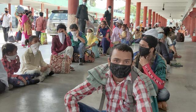 Migrants waiting for their turn for medical screening at Ludhiana inter-state bus terminus on Monday. (Gurpreet Singh/HT) Migrants waiting for their turn for medical screening at Ludhiana inter-state bus terminus on Monday. (Gurpreet Singh/HT)