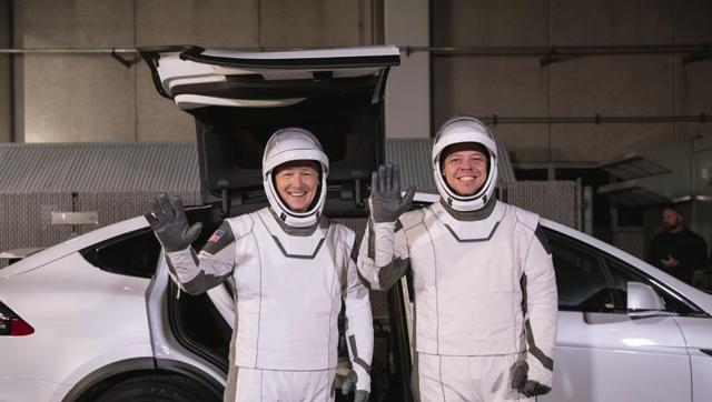 In this Friday, Jan. 17, 2020 photo made available by NASA, astronauts Doug Hurley, left, and Robert Behnken pose in front of a Tesla Model X car during a SpaceX launch dress rehearsal at Kennedy Space Center in Cape Canaveral, Fla. (AP) In this Friday, Jan. 17, 2020 photo made available by NASA, astronauts Doug Hurley, left, and Robert Behnken pose in front of a Tesla Model X car during a SpaceX launch dress rehearsal at Kennedy Space Center in Cape Canaveral, Fla. (AP)
