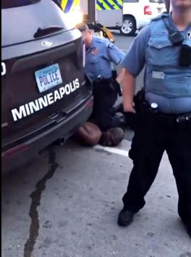 Police officer in this picture can be seen pressing his knee to the head of George Floyd. He was fired but it didn’t stem the outrage in the city. (@K9Falo/Twitter)