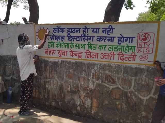 A youth volunteer working on a wall in one of the areas in North Delhi district. A youth volunteer working on a wall in one of the areas in North Delhi district.