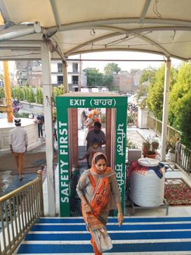 Volunteers coming out of the sanitising tunnel in Gurdwara Dukh Niwaran Sahib in Ludhiana on Sunday. (HT PHOTO) Volunteers coming out of the sanitising tunnel in Gurdwara Dukh Niwaran Sahib in Ludhiana on Sunday. (HT PHOTO)