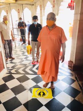 Kalkaji Temple mahant Pt Surendranath Avdhoot inspects the stickers that have been pasted on the floors to ensure social distancing by devotees Kalkaji Temple mahant Pt Surendranath Avdhoot inspects the stickers that have been pasted on the floors to ensure social distancing by devotees
