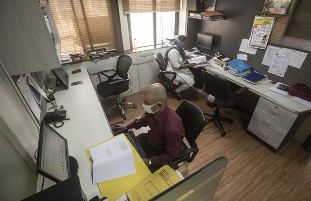Employers at this private office in Shivajinagar ensured that the seating arrangement of the staff is such that social distancing is maintained at all times. (Pratham Gokhale/HT Photo) Employers at this private office in Shivajinagar ensured that the seating arrangement of the staff is such that social distancing is maintained at all times. (Pratham Gokhale/HT Photo)