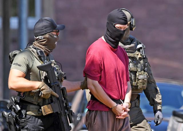 Stephan E., supected of killing the administrative chief of the western city of Kassel Walter Luebcke, is escorted by police back to a helicopter after a hearing at the Federal Court of Justice in Karlsruhe, southern Germany (AFP) Stephan E., supected of killing the administrative chief of the western city of Kassel Walter Luebcke, is escorted by police back to a helicopter after a hearing at the Federal Court of Justice in Karlsruhe, southern Germany (AFP)