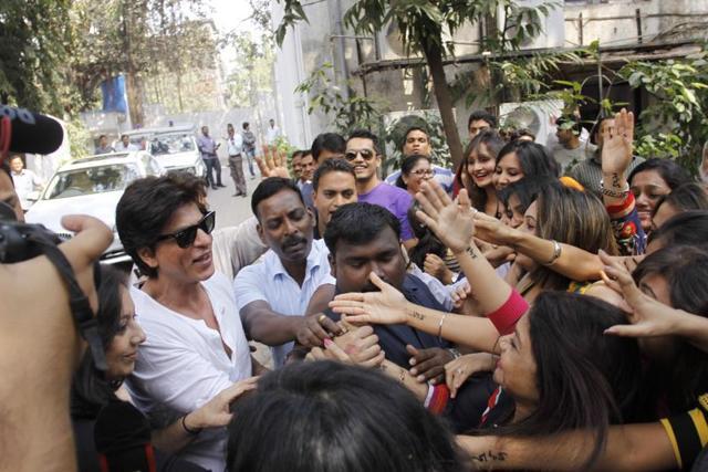 Actor Shah Rukh Khan greeting his fans with his smile and handshakes seems to be a thing of the past in Covid-19 times. Actor Shah Rukh Khan greeting his fans with his smile and handshakes seems to be a thing of the past in Covid-19 times.
