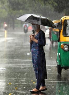 A woman making her way through the rain in Mohali on Friday. (HT Photo ) A woman making her way through the rain in Mohali on Friday. (HT Photo )