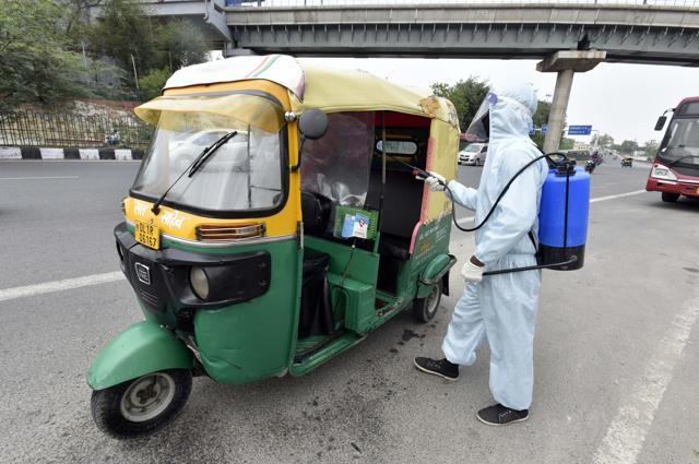 Naresh, in PPE gear, is spotted disinfecting auto rickshaws near Kalkaji Mandir in Delhi. Naresh worked as a delivery person for Swiggy earlier, but was laid off during the lockdown. From a daily earning of
₹200/day previously, his job as a sanitisation worker now gets him as much as
₹500/day. (Photo: Sanjeev Verma/HT ) Naresh, in PPE gear, is spotted disinfecting auto rickshaws near Kalkaji Mandir in Delhi. Naresh worked as a delivery person for Swiggy earlier, but was laid off during the lockdown. From a daily earning of
₹200/day previously, his job as a sanitisation worker now gets him as much as
₹500/day. (Photo: Sanjeev Verma/HT )