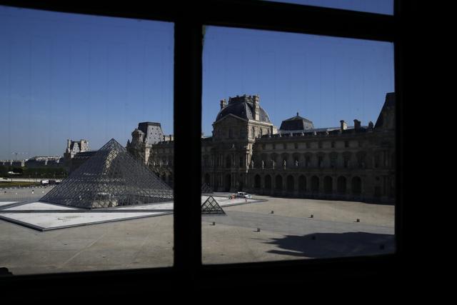 The pyramid of the Louvre museum is pictured through a window during a visit as part of its reopening next July 6, in Paris, Tuesday, June 23, 2020. Before mass tourism came to a screeching halt with the coronavirus pandemic, the Louvre drew up to 50,000 visitors per day, and when they reopen on upcoming July 6, they are counting on the world’s most famous portrait, the “Mona Lisa” to help lure back visitors. (AP) The pyramid of the Louvre museum is pictured through a window during a visit as part of its reopening next July 6, in Paris, Tuesday, June 23, 2020. Before mass tourism came to a screeching halt with the coronavirus pandemic, the Louvre drew up to 50,000 visitors per day, and when they reopen on upcoming July 6, they are counting on the world’s most famous portrait, the “Mona Lisa” to help lure back visitors. (AP)