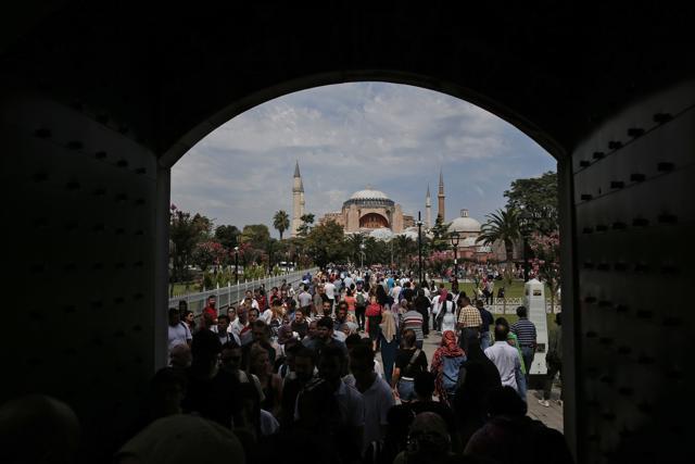FILE - In this Friday, Aug. 17, 2018 file photo, visitors walk towards the Byzantine-era Hagia Sophia, one of Istanbul's main tourist attractions, in the historic Sultanahmet district of Istanbul. (AP) FILE - In this Friday, Aug. 17, 2018 file photo, visitors walk towards the Byzantine-era Hagia Sophia, one of Istanbul's main tourist attractions, in the historic Sultanahmet district of Istanbul. (AP)