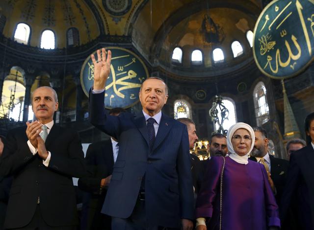 FILE - In this Saturday, March 31, 2018 file photo, Turkey's President Recep Tayyip Erdogan, centre, accompanied by his wife Emine, right, waves to supporters as he walks in the Byzantine-era Hagia Sophia, an UNESCO world heritage site and one of Istanbul's main tourist attractions, in the historic Sultanahmet district of Istanbul. (AP) FILE - In this Saturday, March 31, 2018 file photo, Turkey's President Recep Tayyip Erdogan, centre, accompanied by his wife Emine, right, waves to supporters as he walks in the Byzantine-era Hagia Sophia, an UNESCO world heritage site and one of Istanbul's main tourist attractions, in the historic Sultanahmet district of Istanbul. (AP)