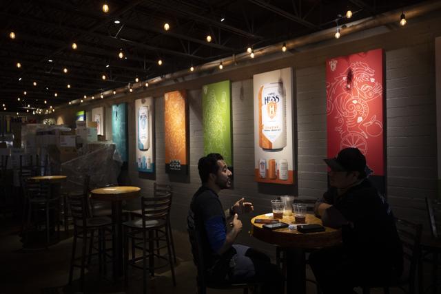 FILE - In this June 29, 2020, file photo, two men drink beers at the Mike Hess brewery and tasting room in San Diego. (AP) FILE - In this June 29, 2020, file photo, two men drink beers at the Mike Hess brewery and tasting room in San Diego. (AP)