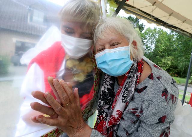 Lily Hendrickx, 83, a resident at Belgian nursing home "Le Jardin de Picardie" enjoys hugs and cuddles with Marie-Christine Desoer. (REUTERS)